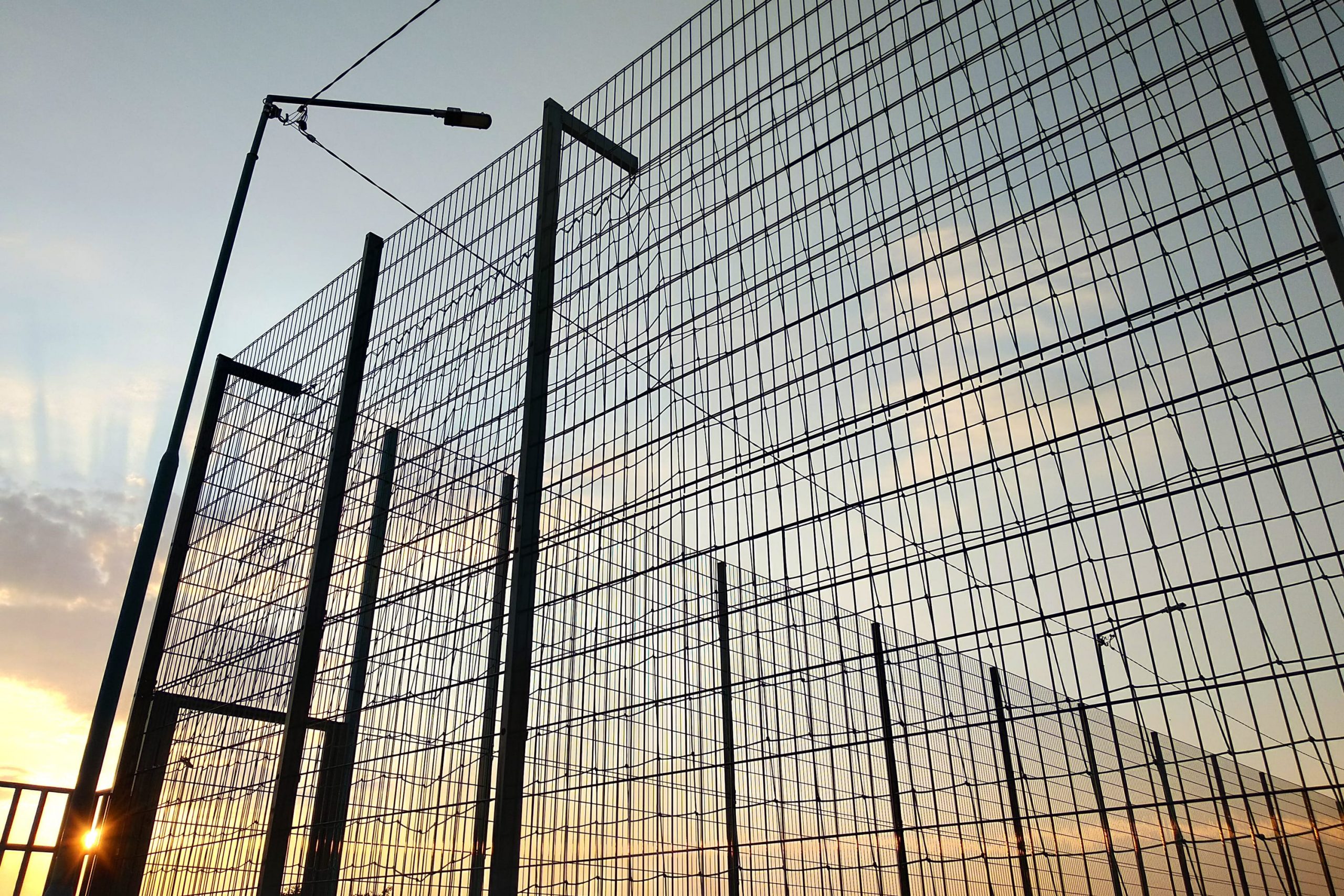 high-wire-mesh-fence-in-restricted-area-on-blue-sk-2022-09-07-18-52-03-utc-min